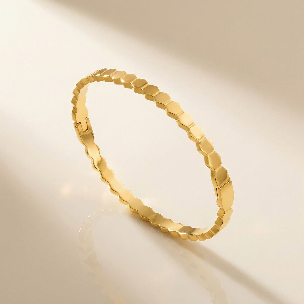 Elevate your style with the ANSHU AURA JEWELLERY Gold Plated Geometric Bracelet. Crafted from premium stainless steel with a luxurious gold-plated finish, this elegant bracelet offers a modern and minimal design perfect for every occasion. Lightweight, co